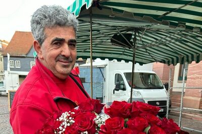Antonio Palumbo zeigt einen üppigen Blumenstrauß mit roten Rosen.