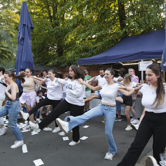 Junge Menschen tanzen Sirtaki.