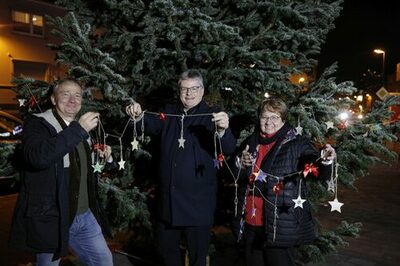 Stadtwerke-Geschäftsführer Peter Walther und Vorstandsmitglieder Gabriele E. Ring und Daniel Wiljotti schmücken den Weihnachtsbaum